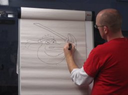 Neill Cameron drawing at a comic book workshop